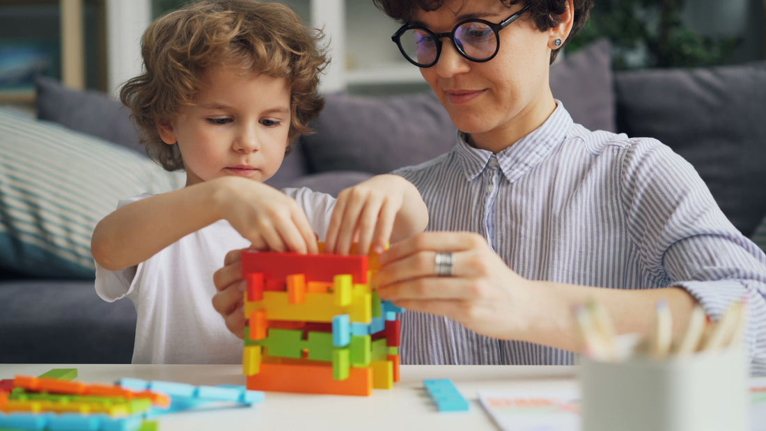 Parent and child building with colorful building bricks at a family table
