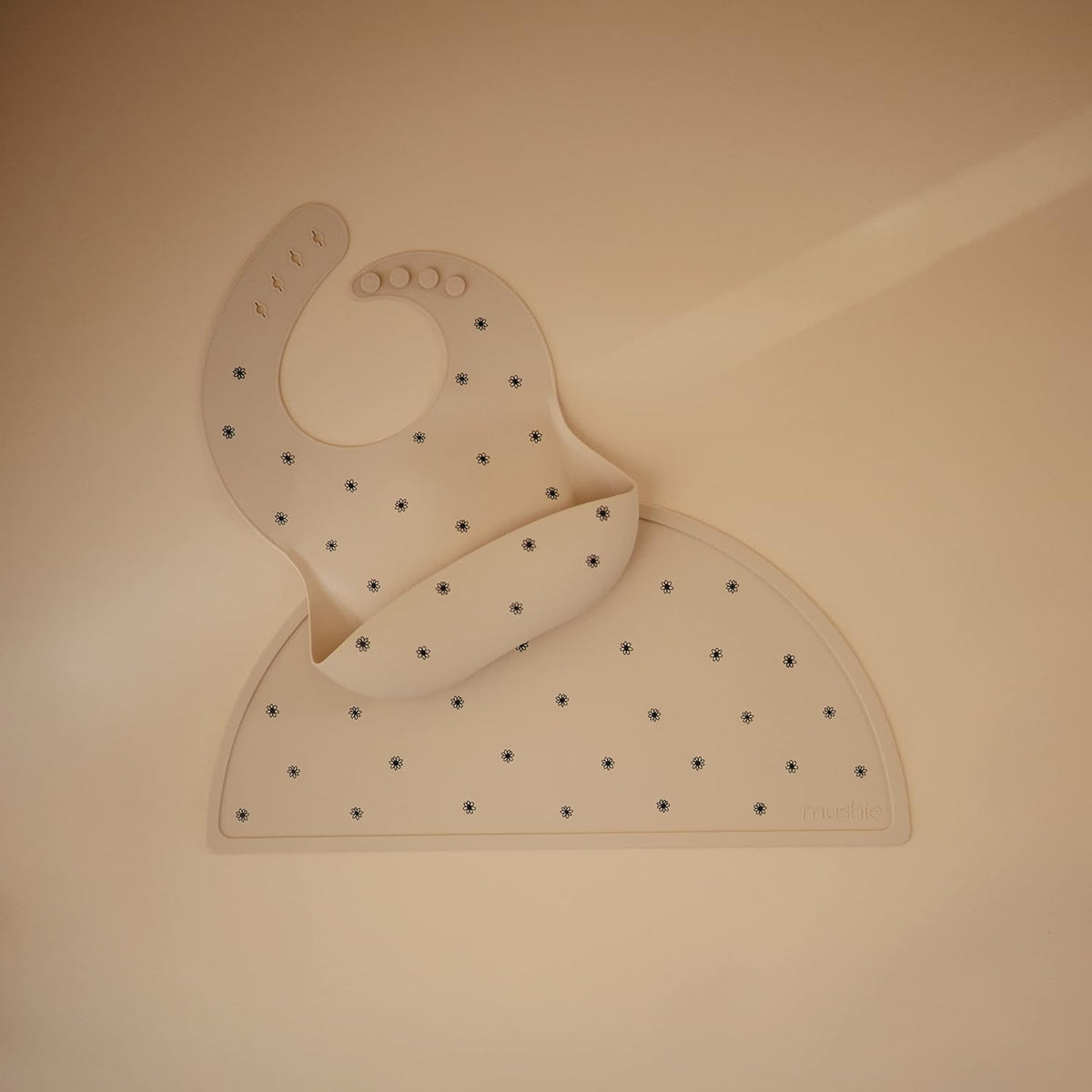 mushie Silicone Baby Bib | Adjustable Fit Waterproof Bibs (Black Daisy)
