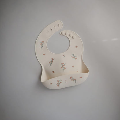mushie Silicone Baby Bib | Adjustable Fit Waterproof Bibs (Pink Flowers)