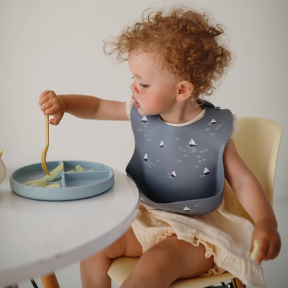 mushie Silicone Baby Bib | Adjustable Fit Waterproof Bibs (Boats)