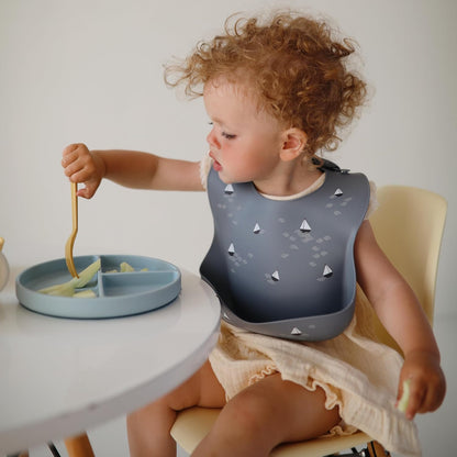 mushie Silicone Baby Bib | Adjustable Fit Waterproof Bibs (Tradewinds)